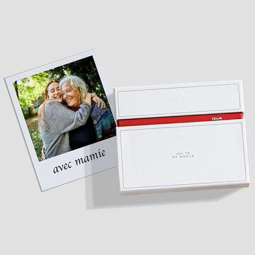 Un livre photo plein d'amour dans une boîte blanche, avec un instantané d'une rencontre heureuse.