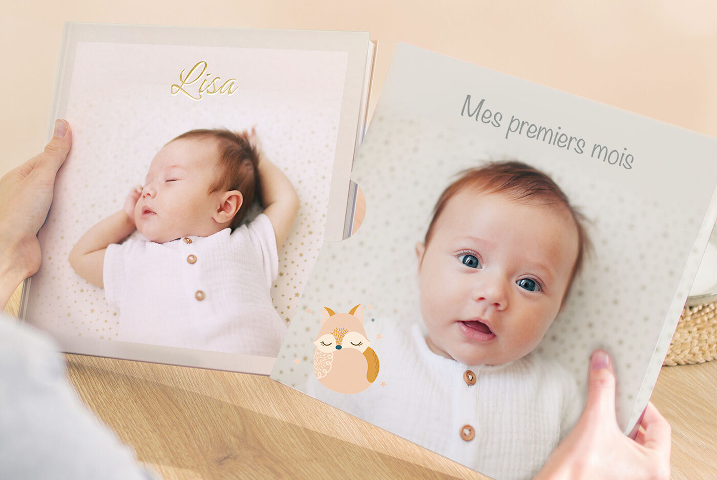Deux livres photo joliment conçus, l'un avec le nom "Lisa" et l'autre avec le titre français "Mes premiers mois", tenus sur une belle table.