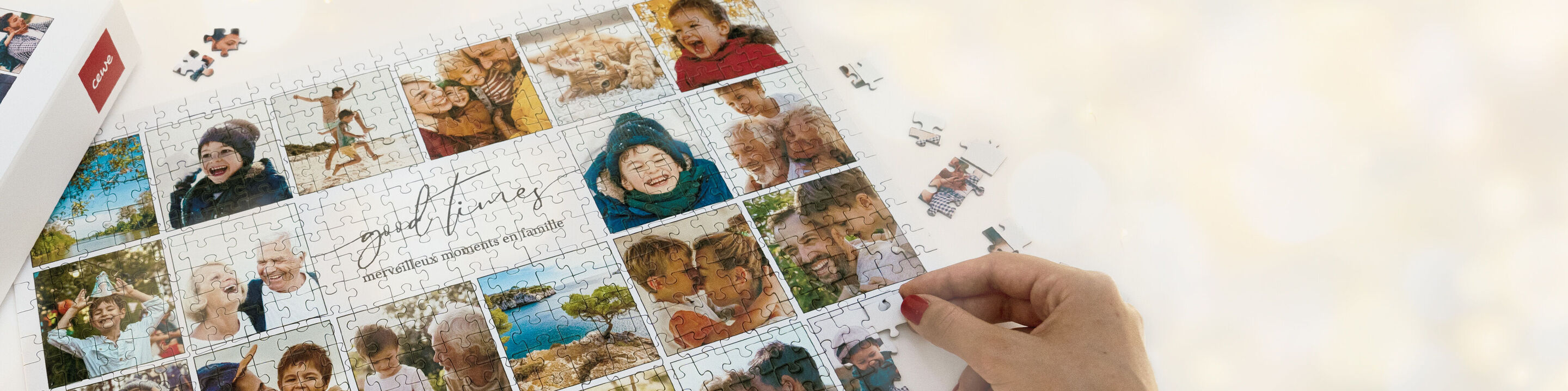 Une personne tient un puzzle photo CEWE avec des photos de famille.