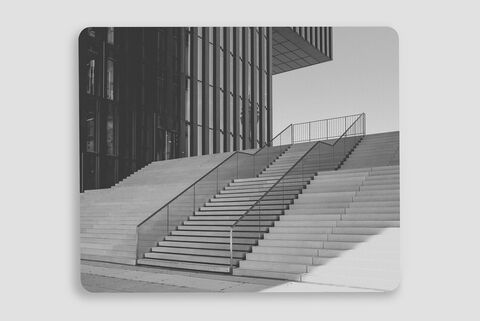 Escalier moderne devant un bâtiment en verre.