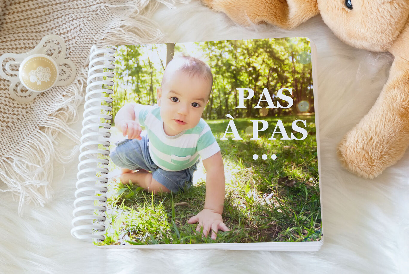 Un petit garçon rampe sur la pelouse et explore la nature.