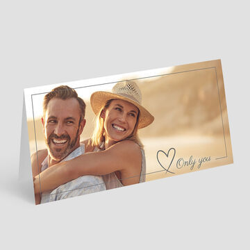 Un couple profite d'une étreinte affectueuse sur la plage, avec des couleurs chaudes à l'arrière-plan.